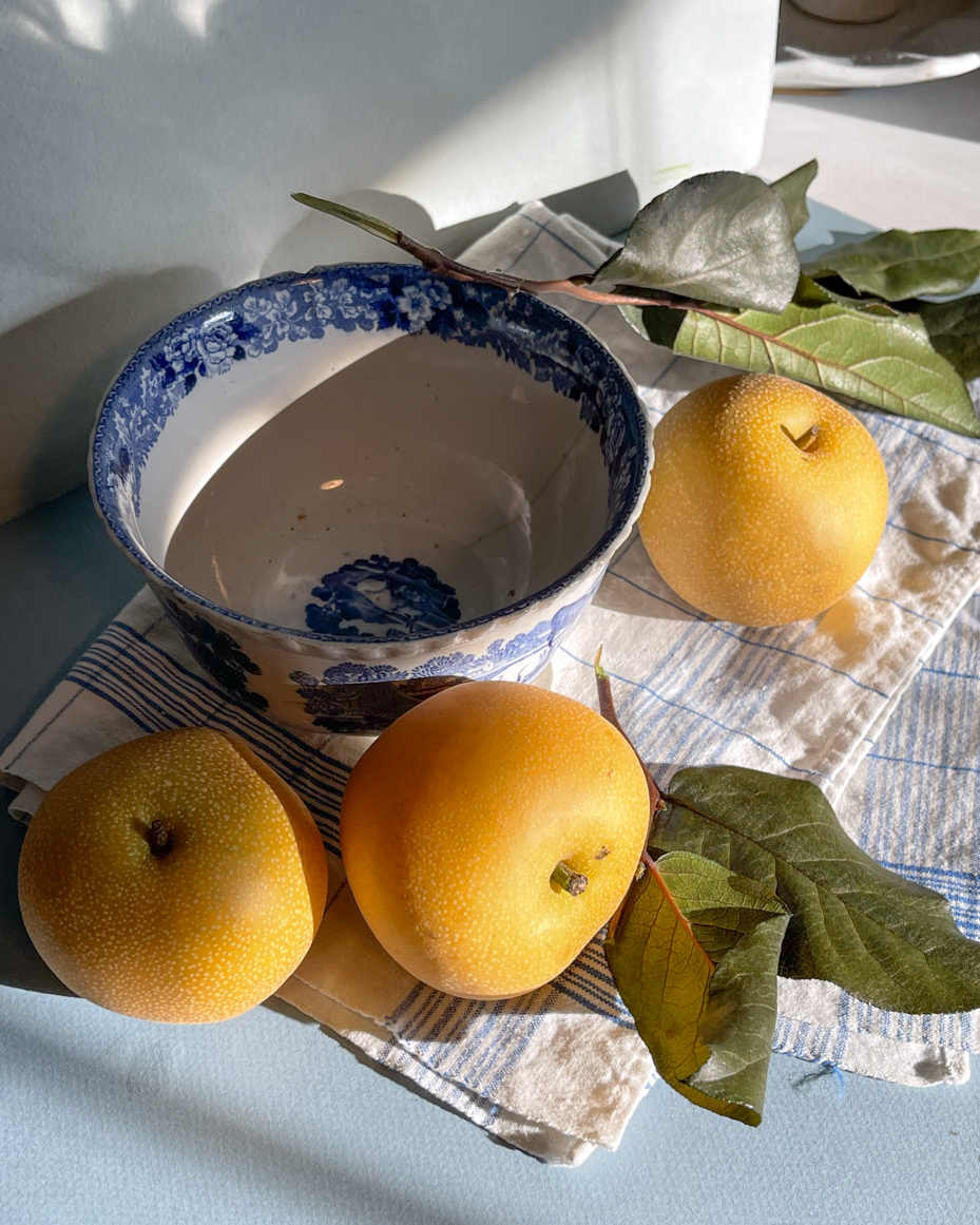 flat-lay-of-asian-pears-leaves-and-bowl