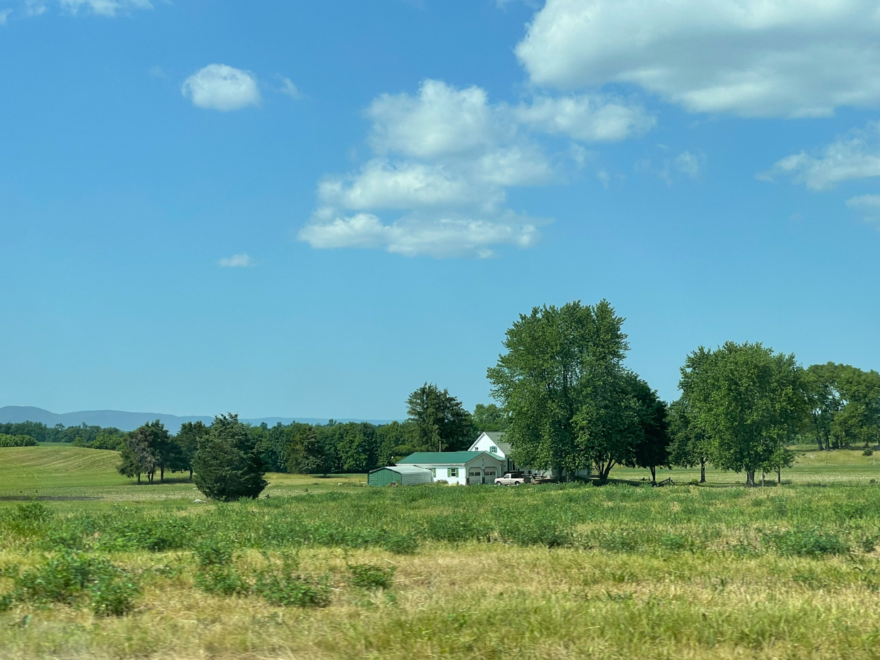 farm-house-surrounded-by-trees-with-clouds