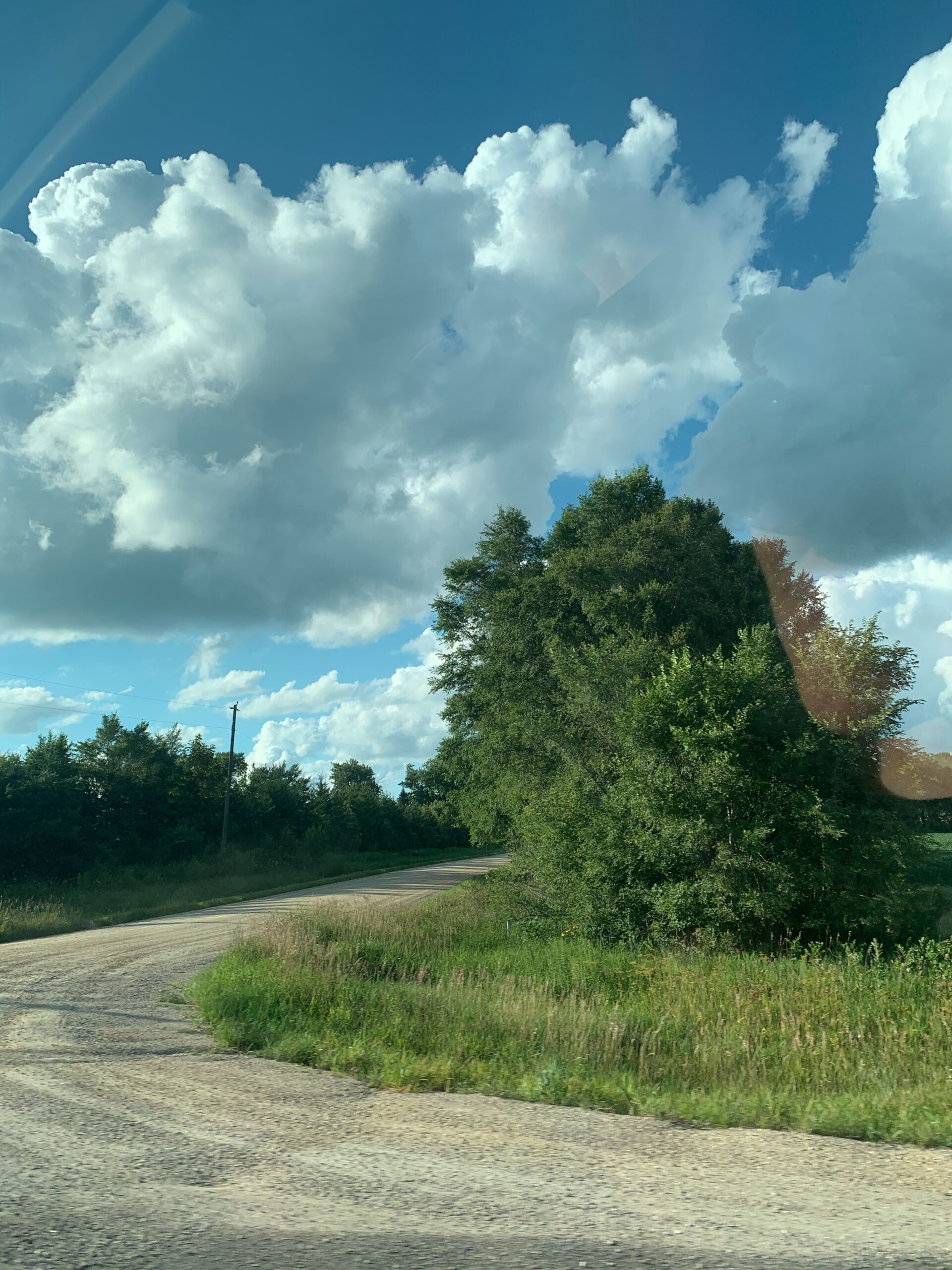 curve-road-with-trees-and-clouds