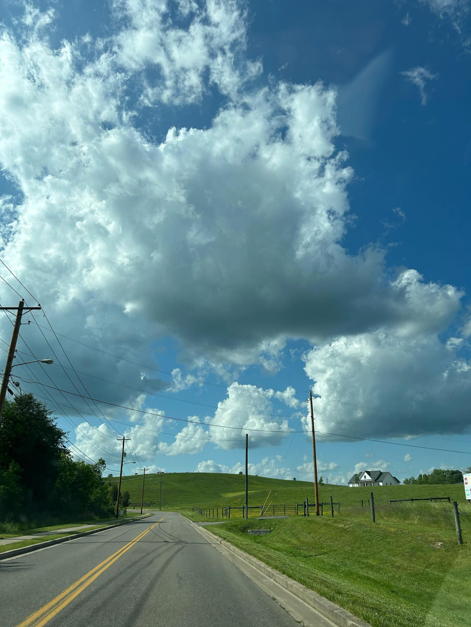 road-along-hillside-and-clouds