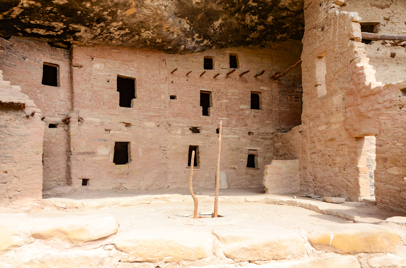 ancient-cliff-dwelling-interior-with-stone-walls-and-wooden-beams-historical-site