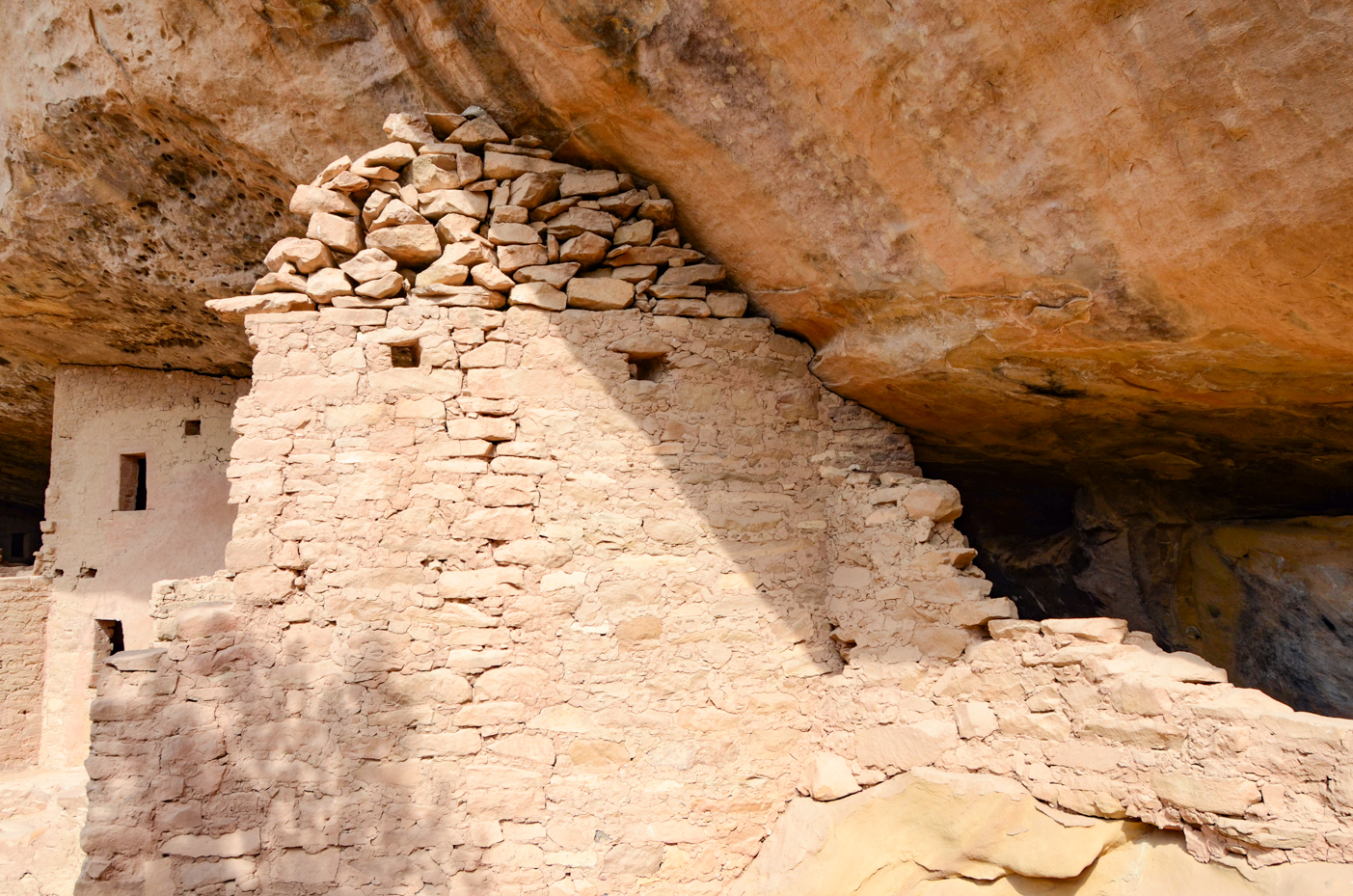 ancient-stone-cliff-dwelling-structure-under-rock-overhang-historical-site