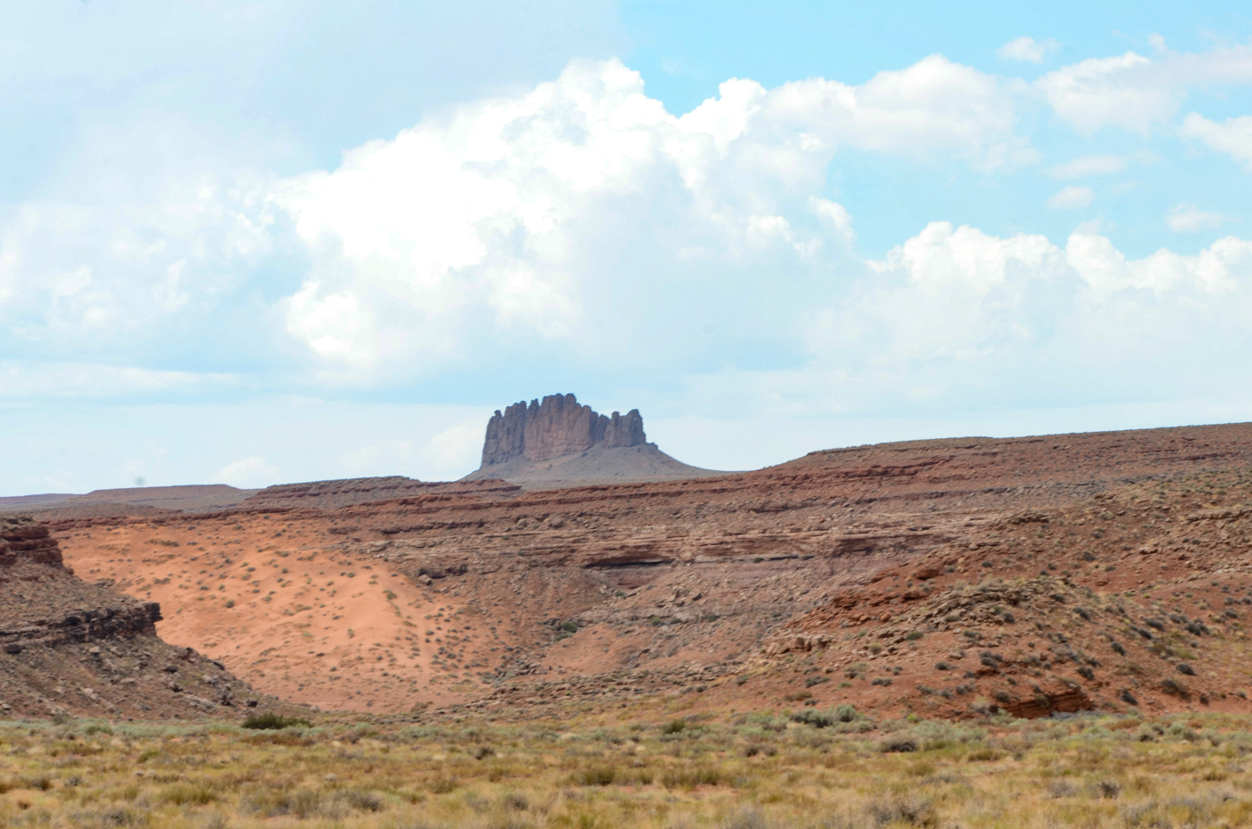 distant-rock-formation-on-desert-landscape-with-cloudy-sky