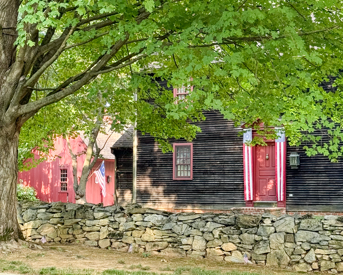 historic-colonial-house-green-tree-stone-wall-red-trim-rustic-americana