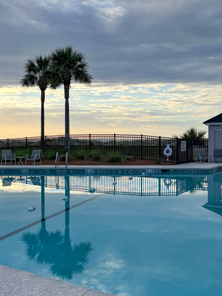 pool-view-with-palm-trees-and-clouds