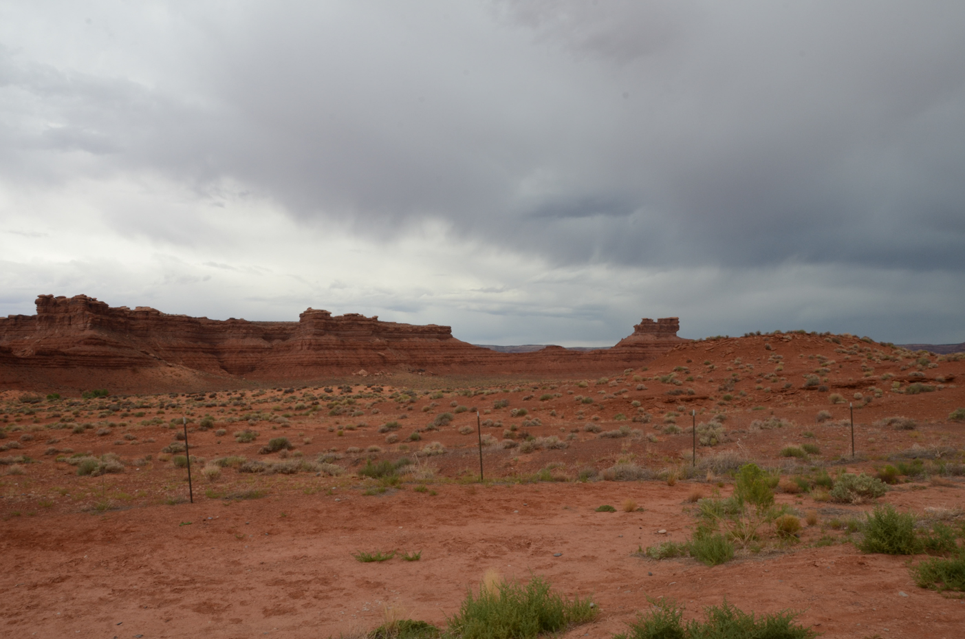 red-desert-landscape-with-rock-formations-under-cloudy-sky