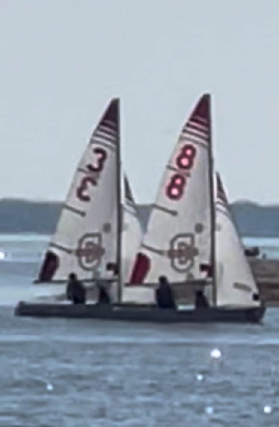 two-sailboats-with-numbered-sails-on-the-water-racing-side-by-side