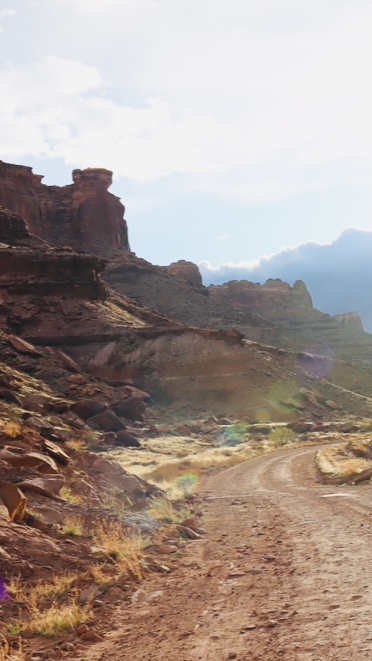 dusty-desert-road-through-red-rock-canyon