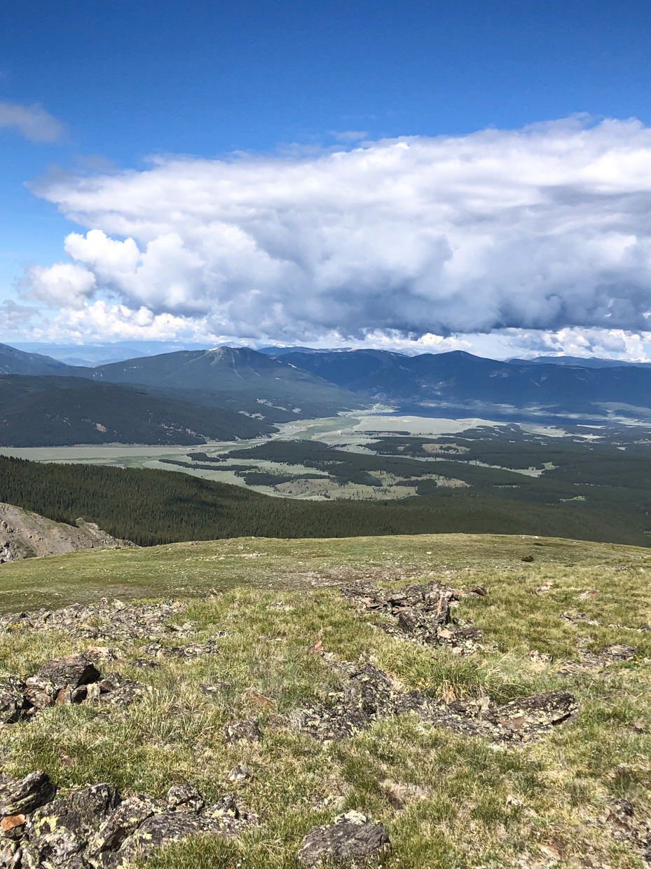 expansive-mountain-valley-with-rolling-hills-and-dramatic-cloud-formations-royalty-free-landscape-reference-photo-for-wilderness-nature-and-scenic-views-photography