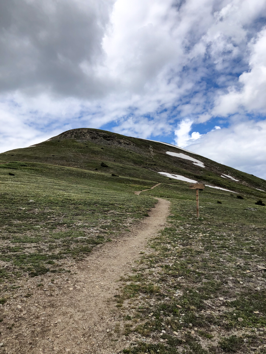 mountain-hiking-trail-leading-to-summit-under-partly-cloudy-sky-royalty-free-nature-and-adventure-reference-photo-for-outdoor-exploration-wilderness-and-scenic-views