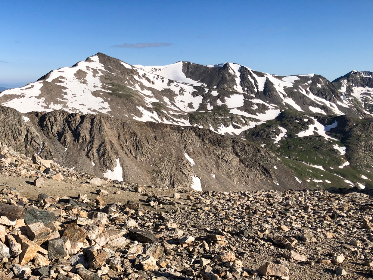 snow-capped-mountain-range-with-rocky-terrain-and-clear-blue-skies