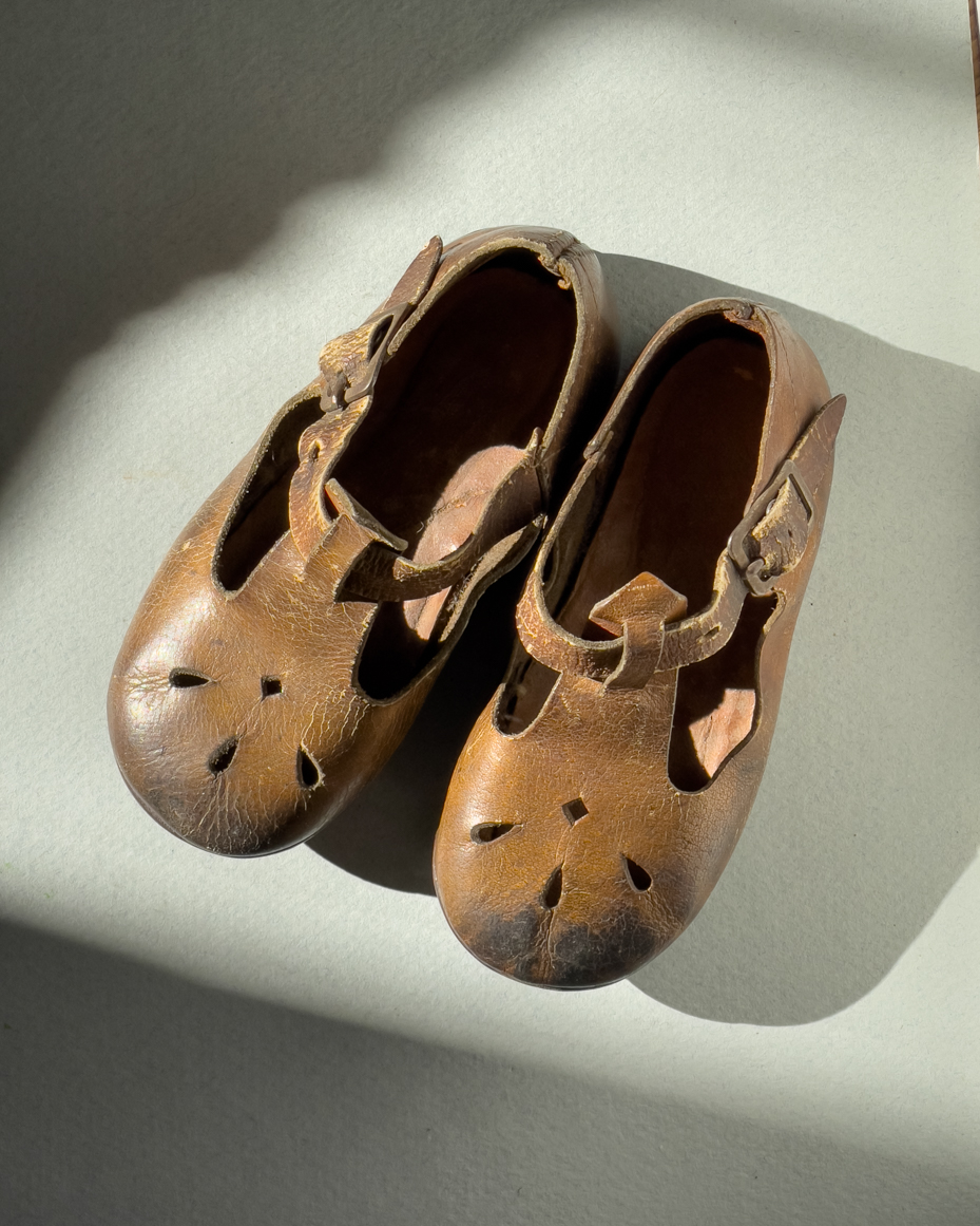 vintage-brown-leather-toddler-shoes-with-cutout-design-in-sunlight-royalty-free-reference-photo