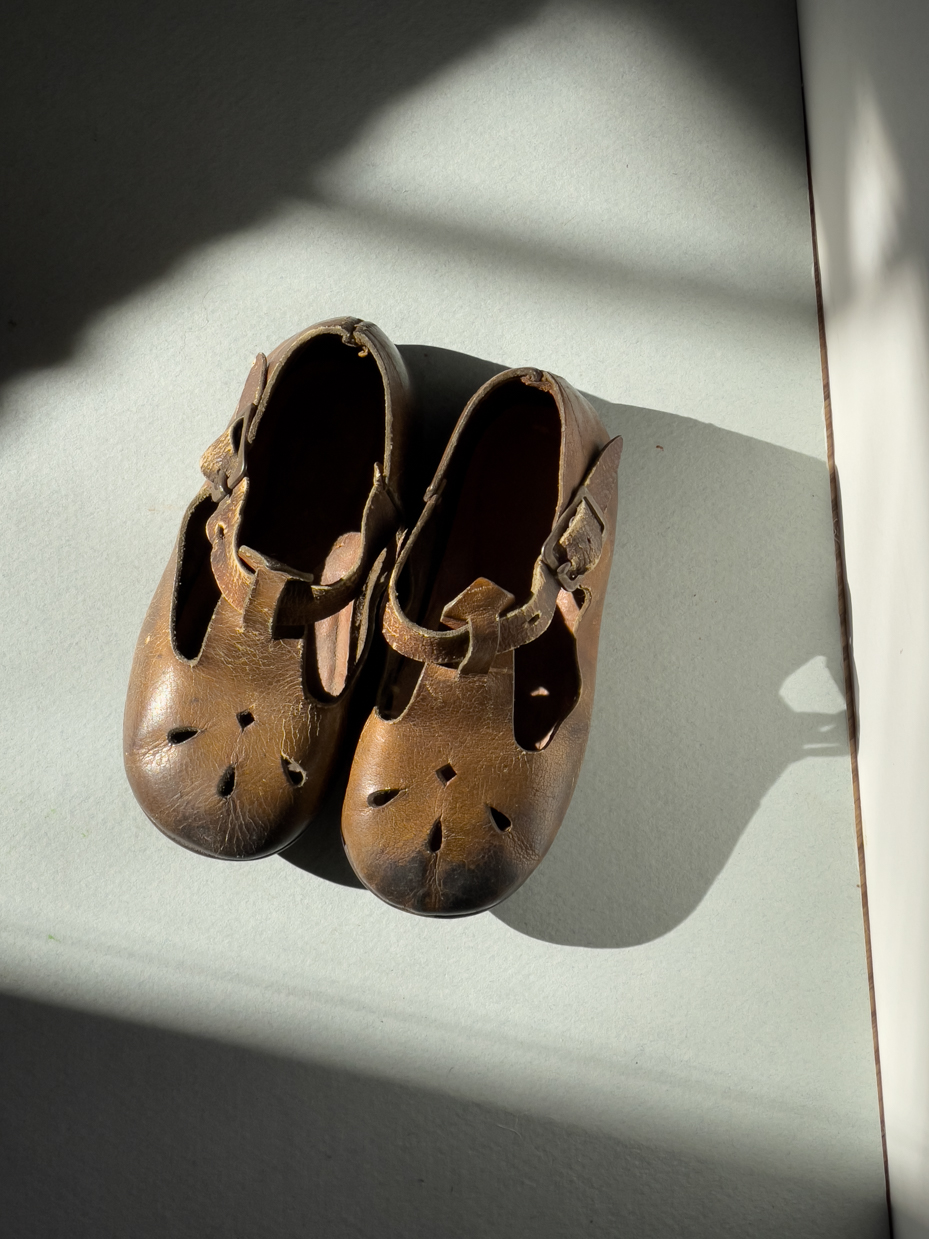 vintage-brown-leather-toddler-shoes-with-t-strap-design-in-sunlight-royalty-free-reference-photo