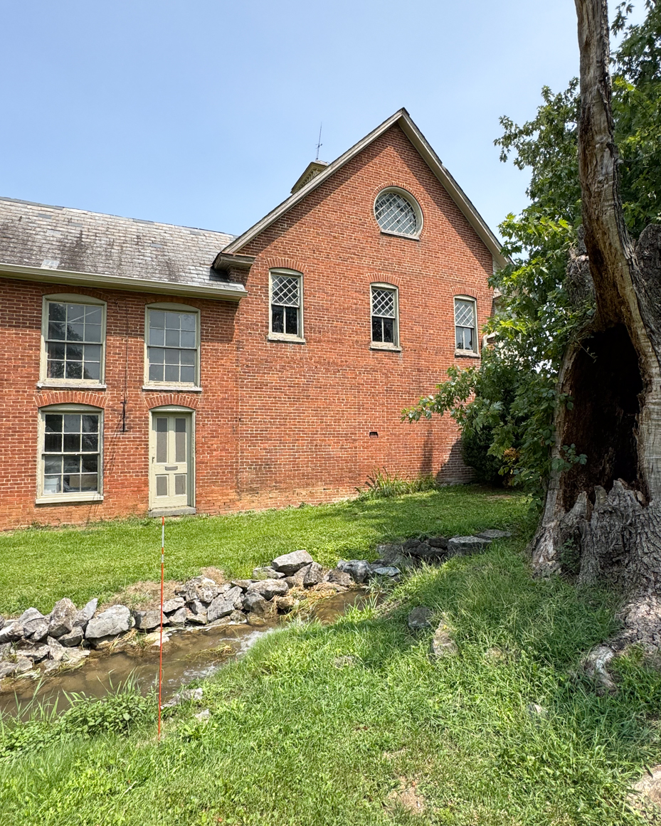 historic-brick-farmhouse-stream-old-tree-rural-architecture