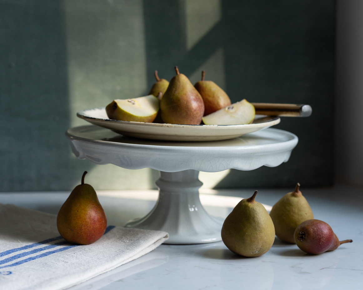 ripe-pears-on-cake-stand-with-linen-rustic-still-life-photography