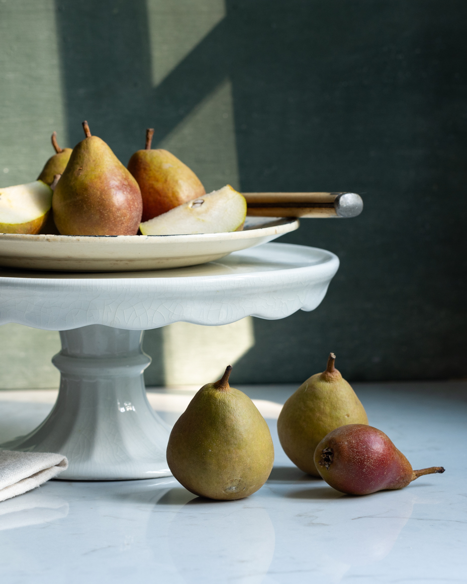 rustic-pears-on-ceramic-stand-with-natural-light-elegant-still-life