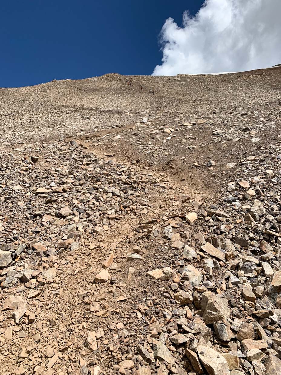 steep-rocky-mountain-trail-leading-to-the-summit-under-a-clear-sky-challenging-hiking-adventure