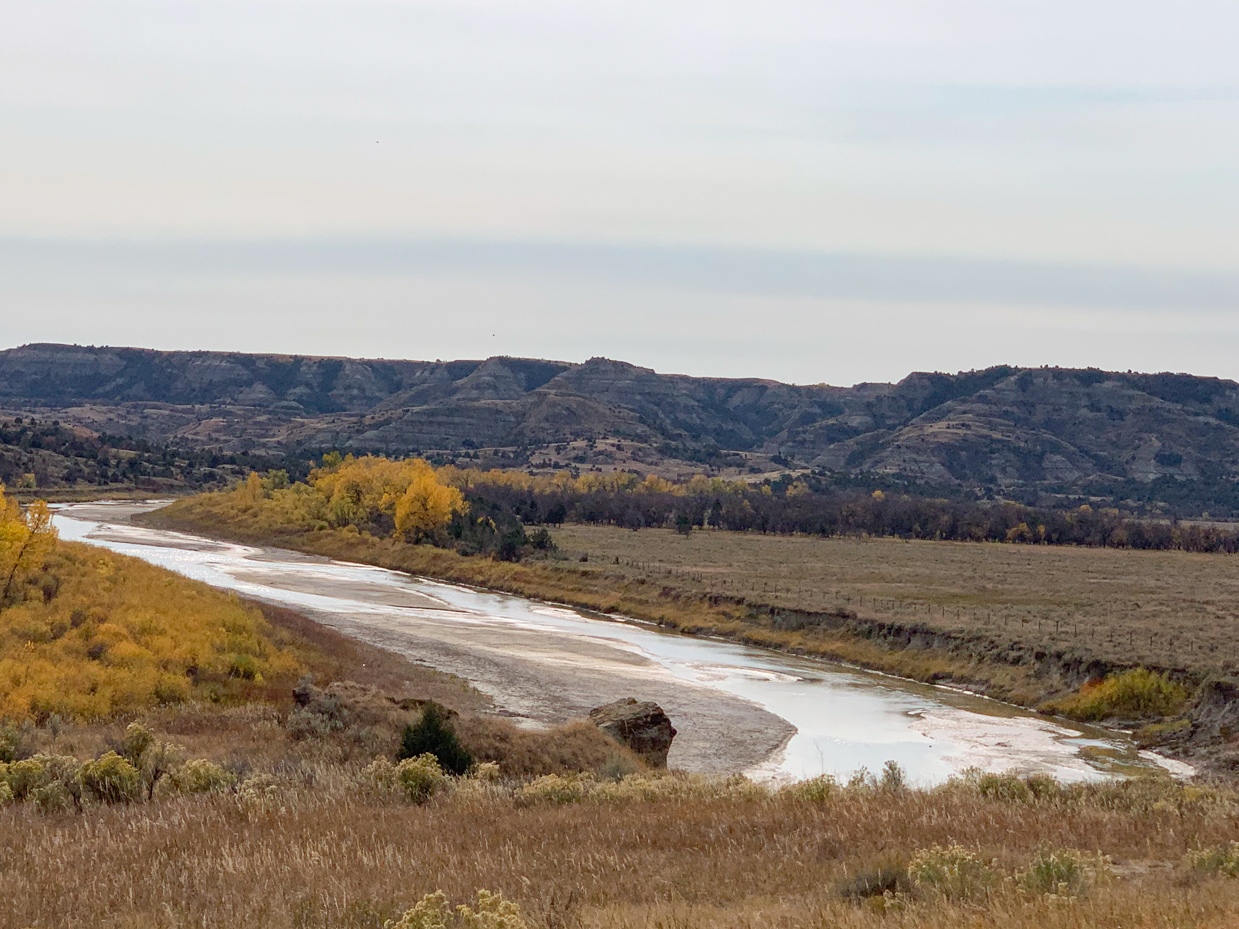 winding-river-through-badlands-terrain-autumn-western-landscape-reference