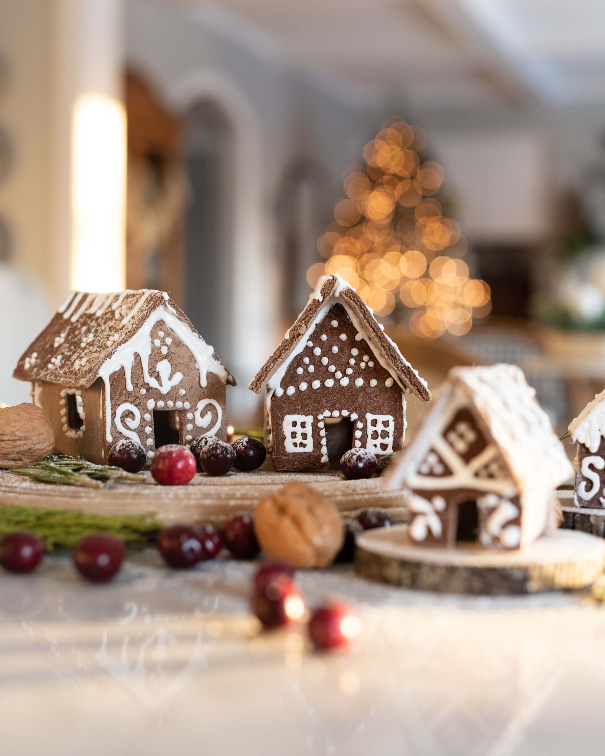 Enchanting Christmas scene featuring two charming gingerbread houses adorned with intricate white icing designs and sprinkles artist reference photo