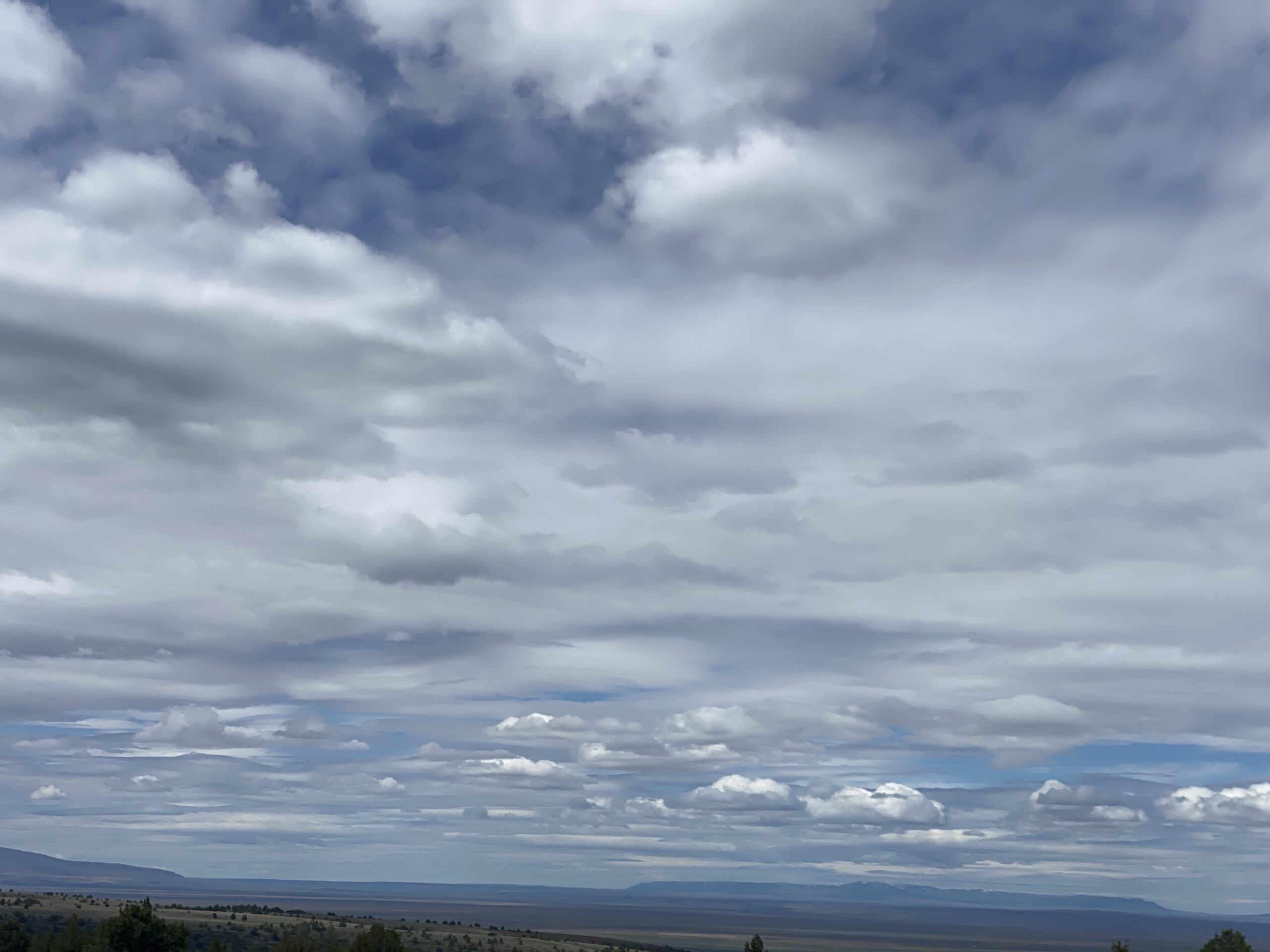 Expansive Landscape with Layered Clouds and Distant Horizon artist reference photo