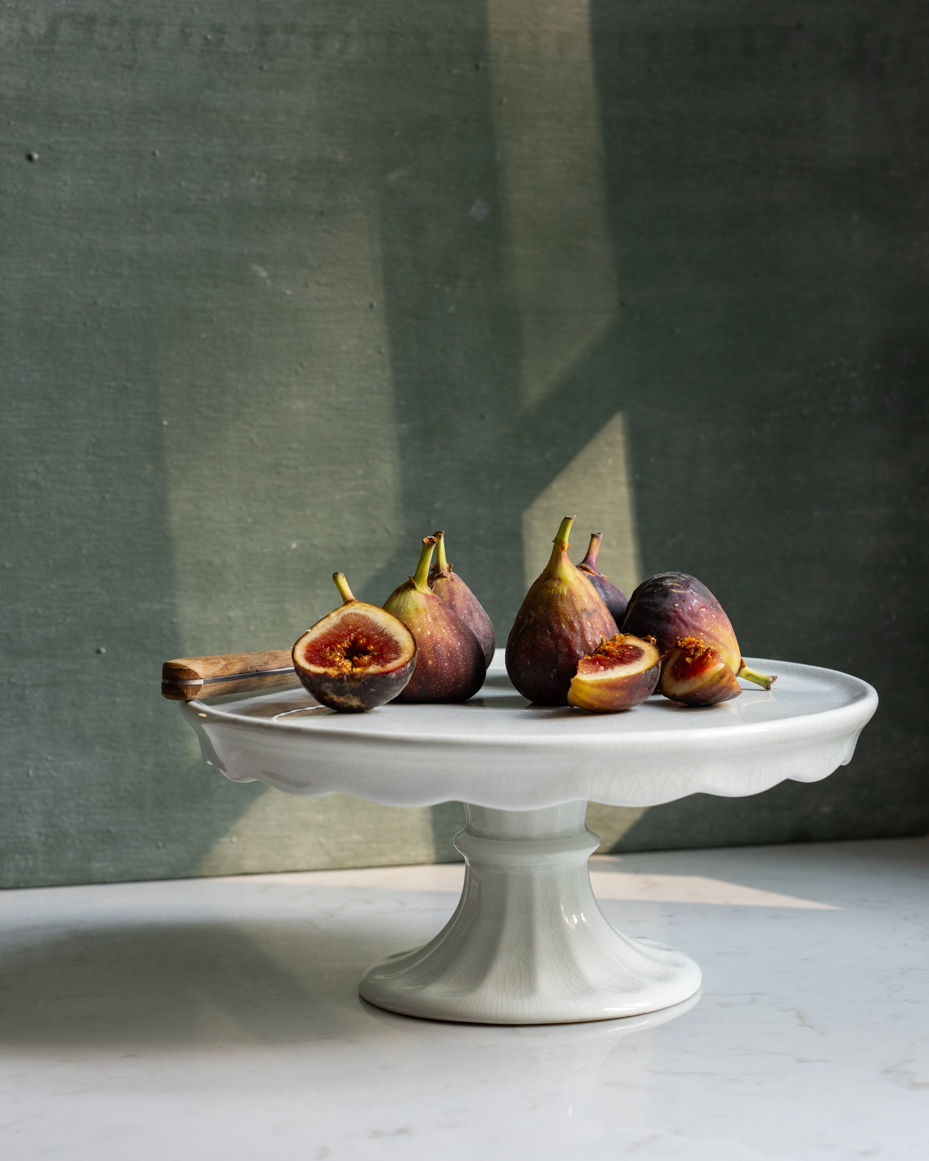 fresh-figs-on-cake-stand-with-natural-light-and-rustic-shadows-still-life