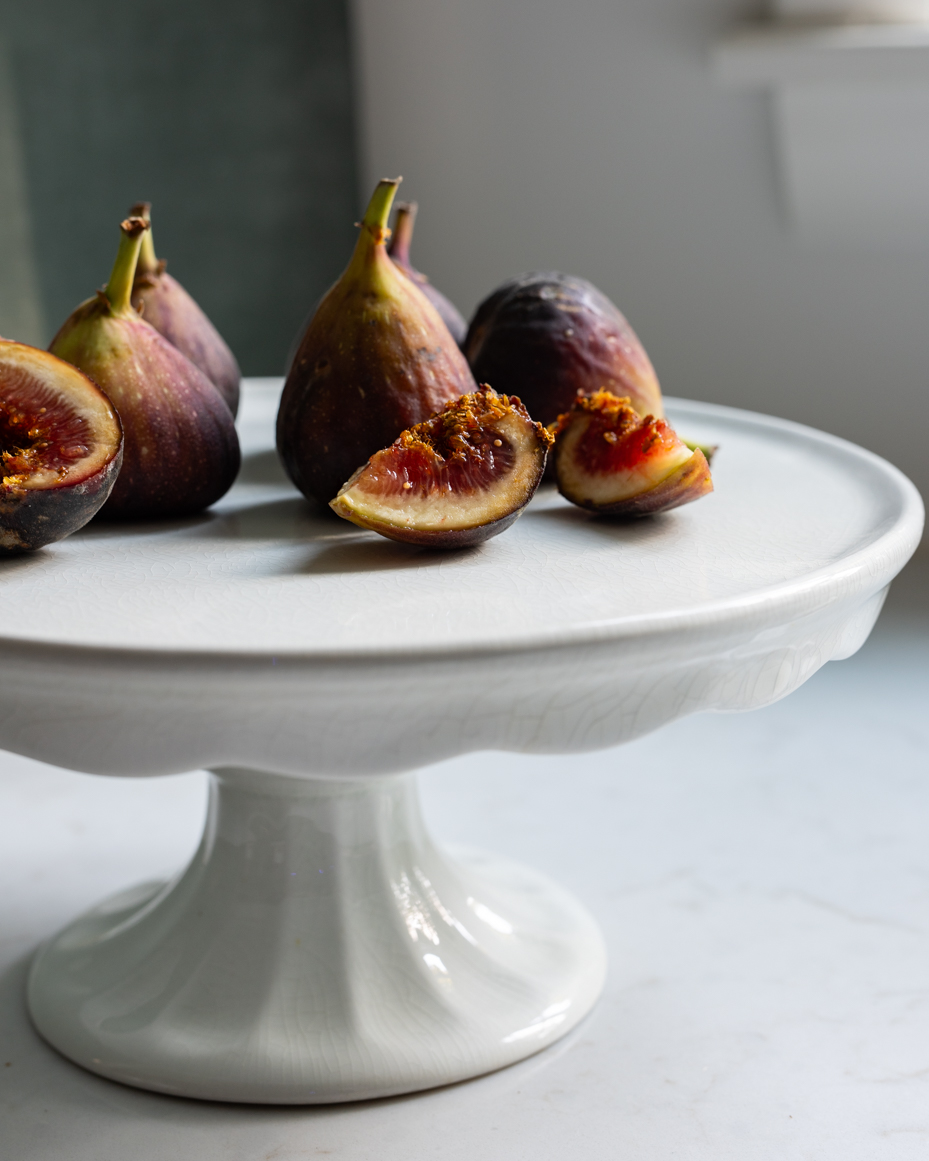 fresh-sliced-figs-on-elegant-cake-stand-natural-light-food-photography