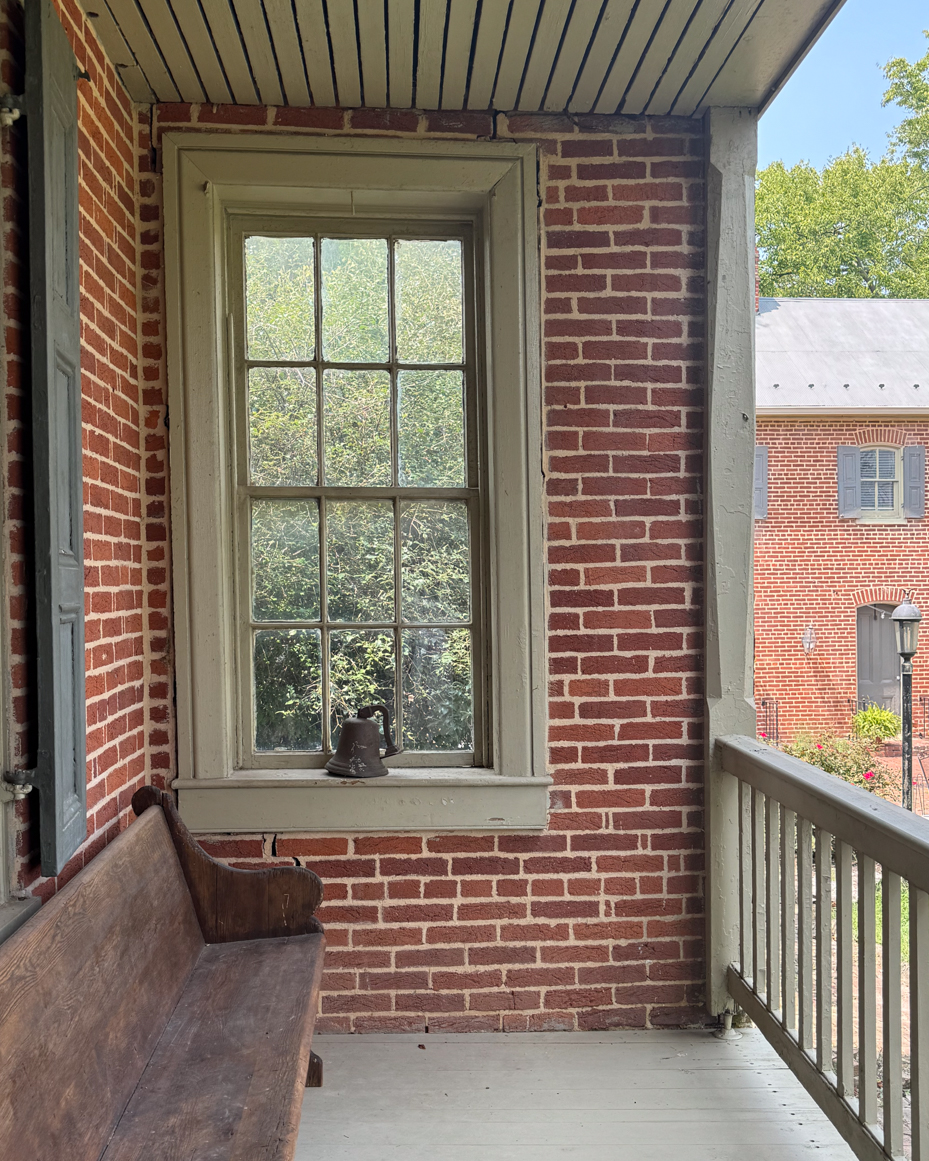 historic-brick-porch-window-seat-rustic-charm-colonial-architecture