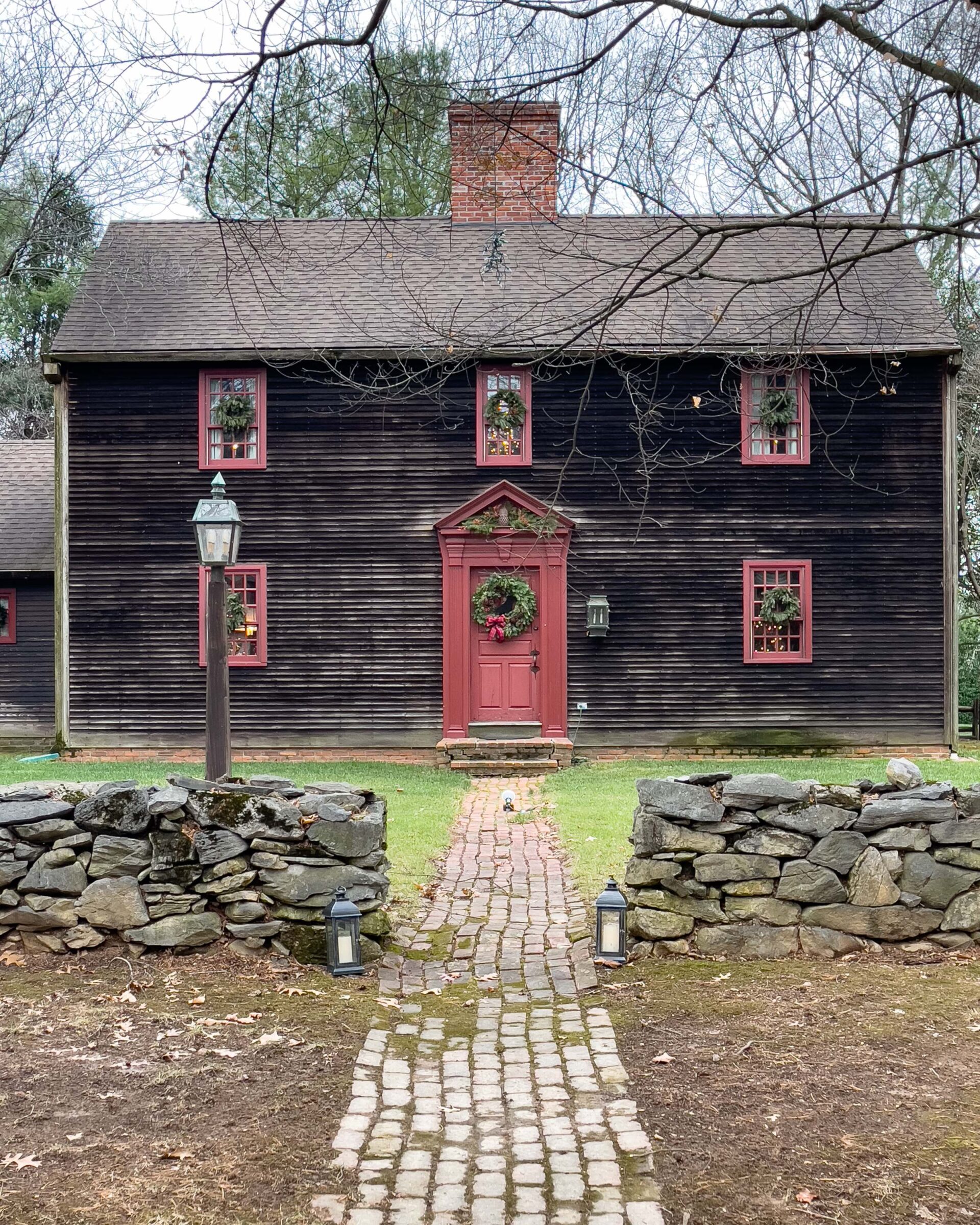 historic-colonial-house-with-red-trim-and-brick-path-holiday-decor