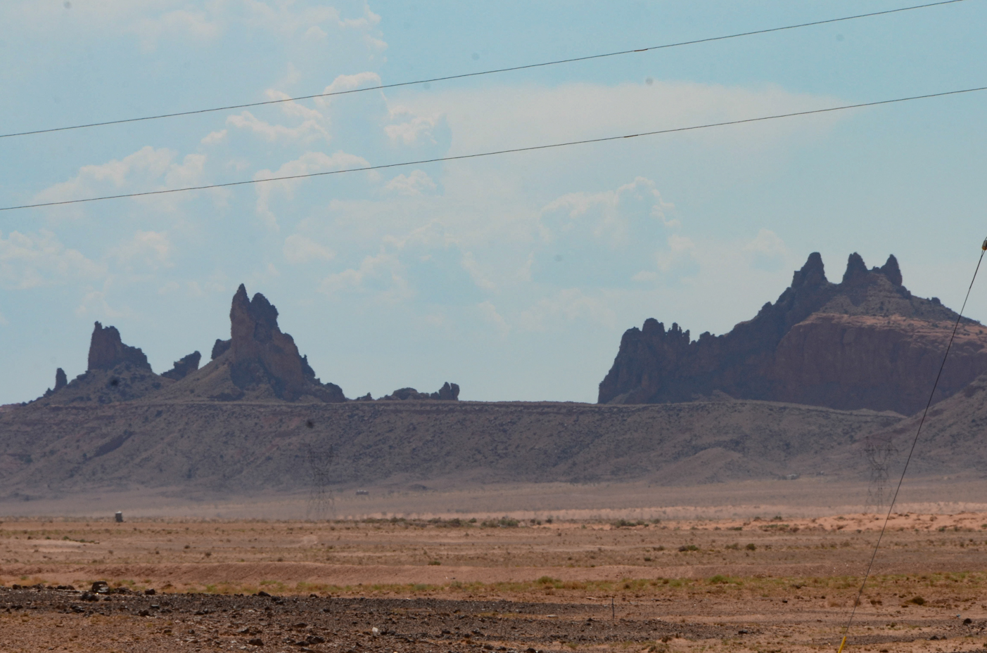 jagged-desert-spires-rising-above-barren-plains-in-shiprock-new-mexico