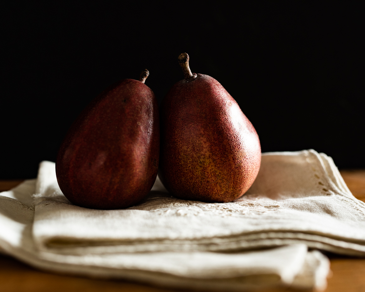 red-pears-on-white-linen-close-up-dark-background-artist-reference