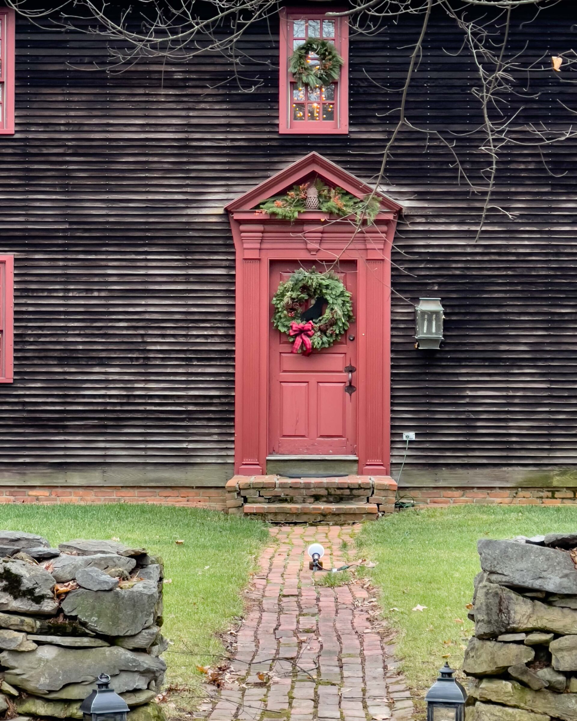 rustic-colonial-home-with-red-door-and-holiday-wreath-winter-decor