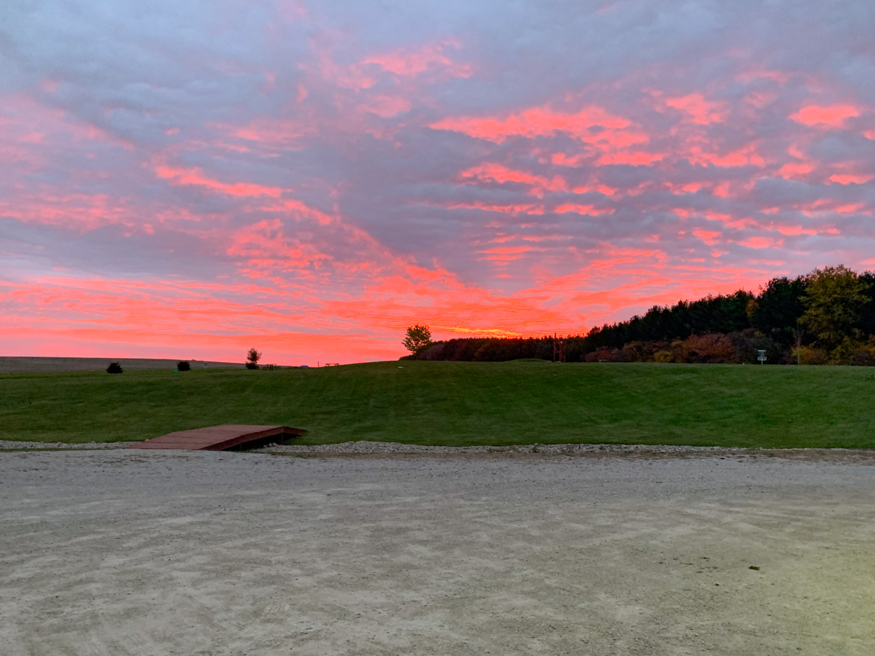 vibrant-sunset-over-open-field-pink-and-orange-sky-in-rural-landscape-royalty-free-reference-photo