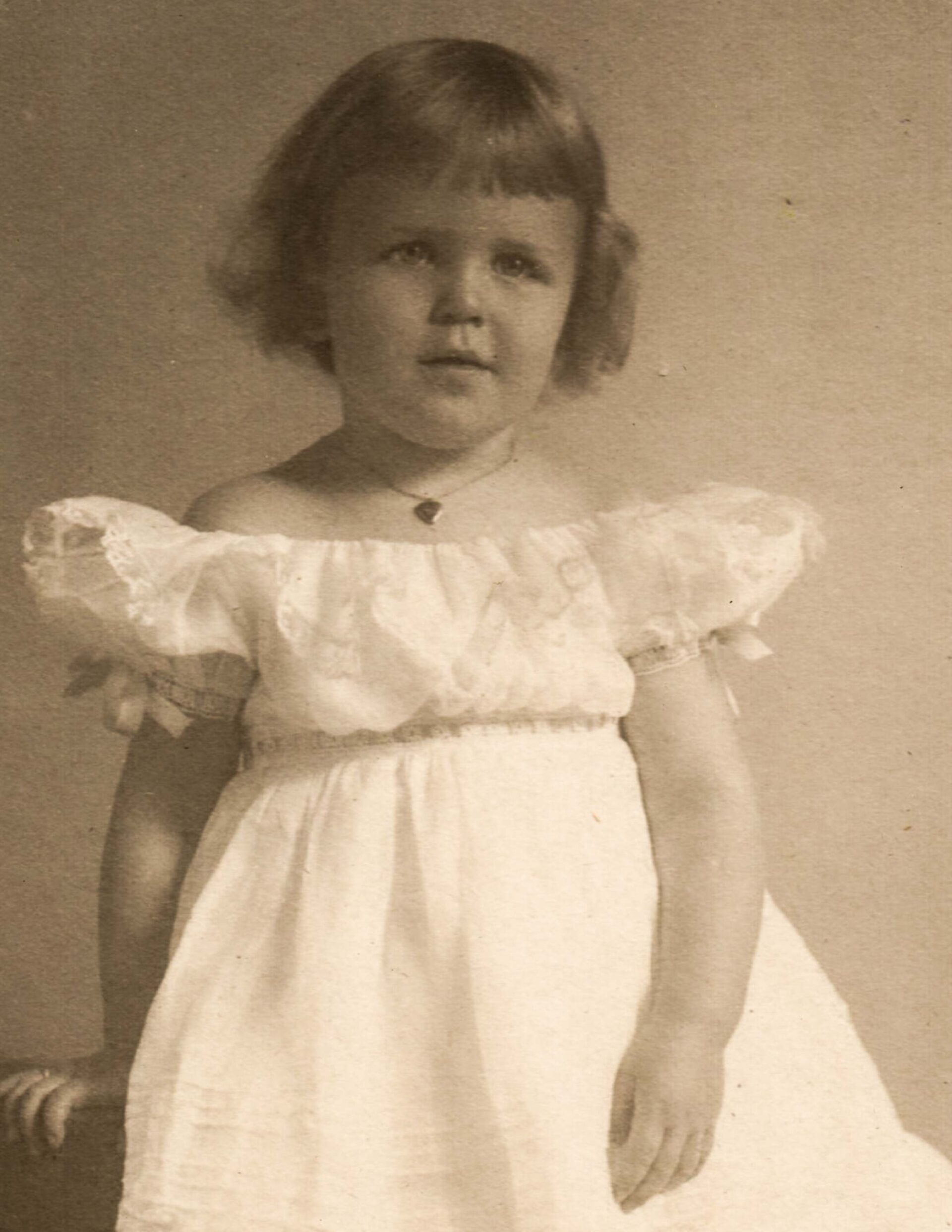 vintage-1920s-portrait-of-young-girl-in-white-dress-studio-photography