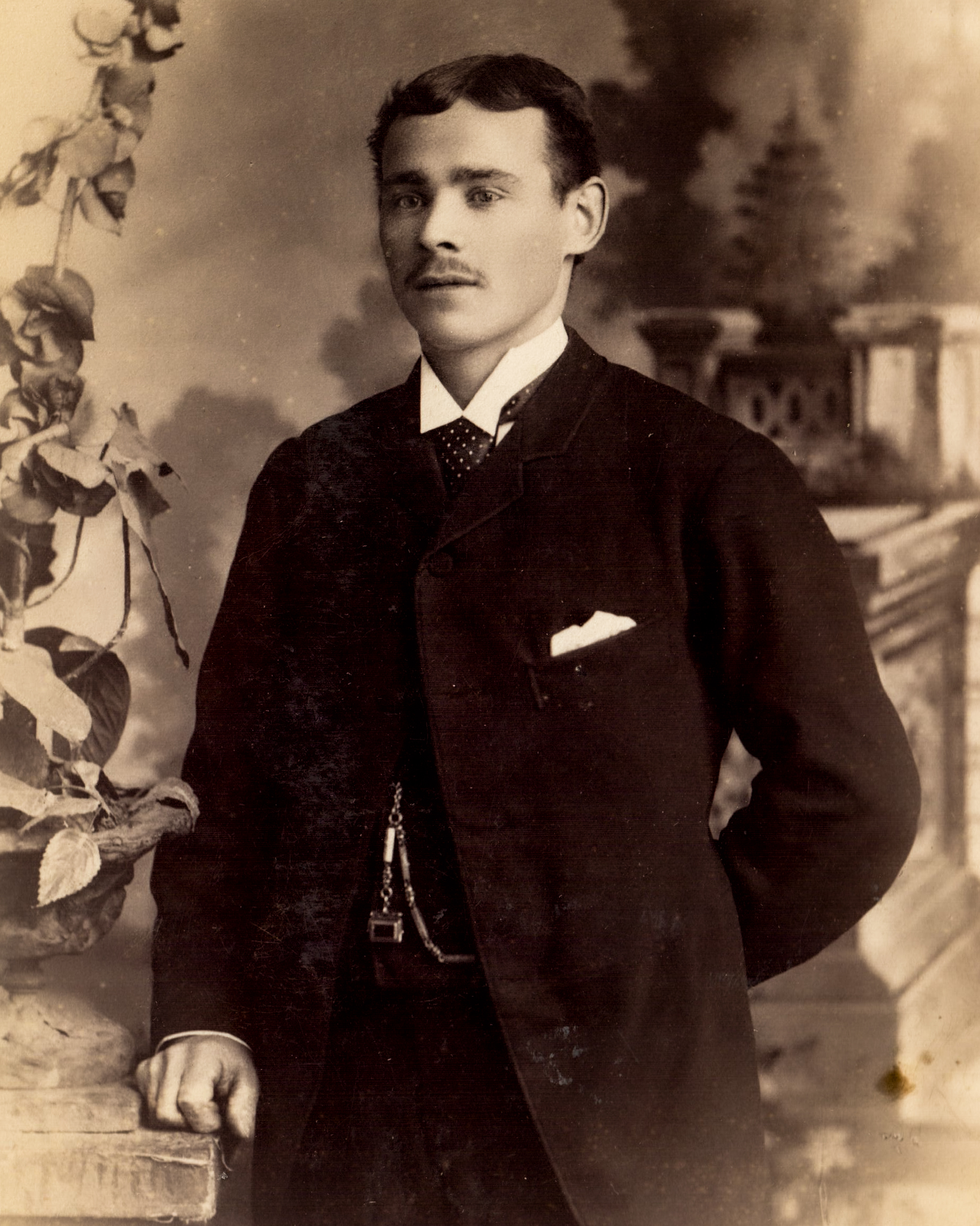 vintage-portrait-of-a-gentleman-in-formal-attire-with-pocket-watch-chain