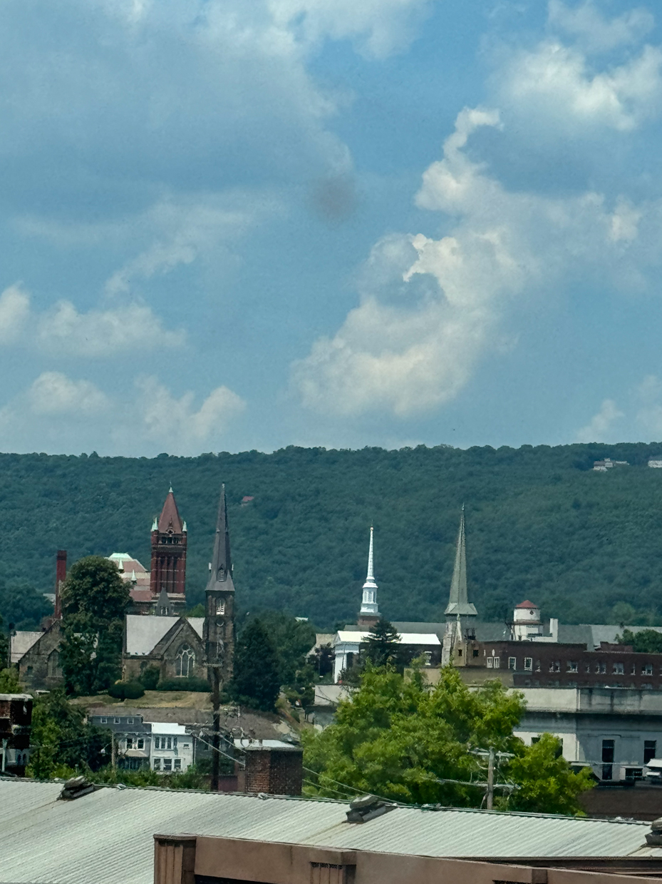 historic-church-towers-skyline-with-mountains-in-background-urban-cityscape-scenic-overlook-royalty-free-photo