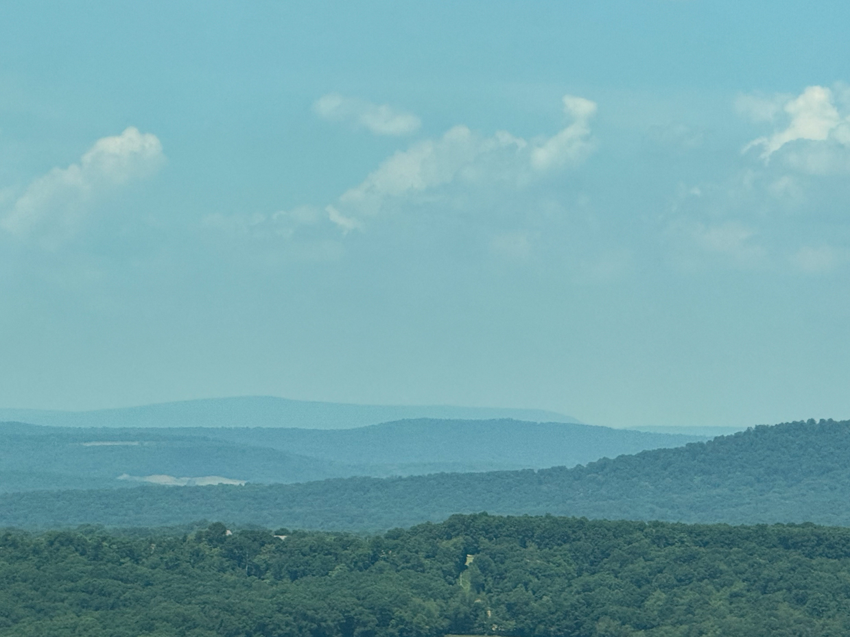 layered-blue-green-forested-mountains-under-cloudy-sky-scenic-vista-royalty-free-photo