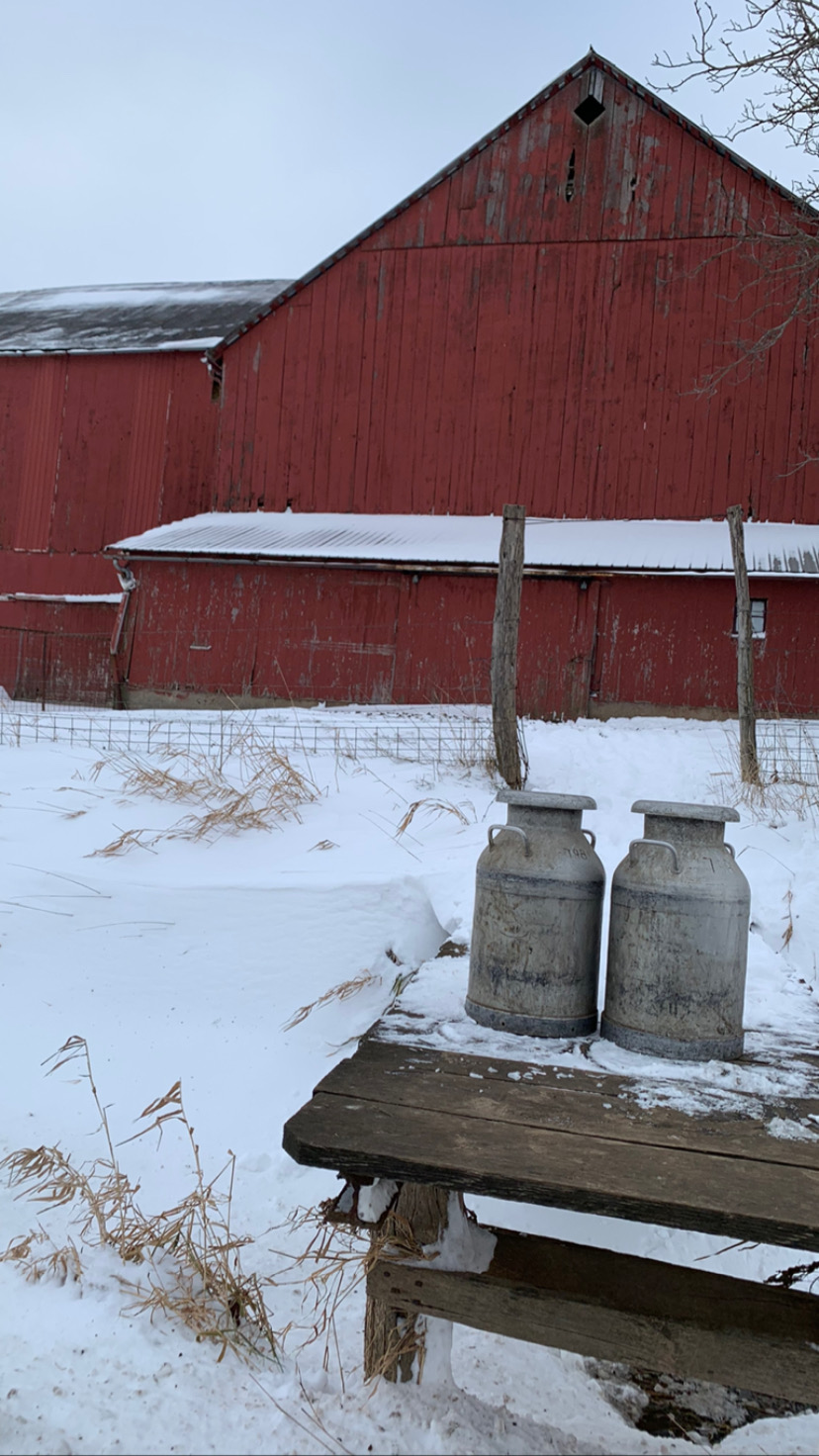 milk-cans-and-red-barn-in-the-snow