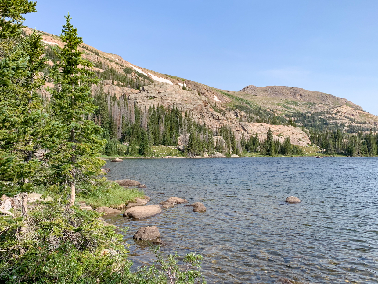 alpine-lake-with-rocky-shore-and-evergreens-rugged-mountain-landscape-artist-reference-photo