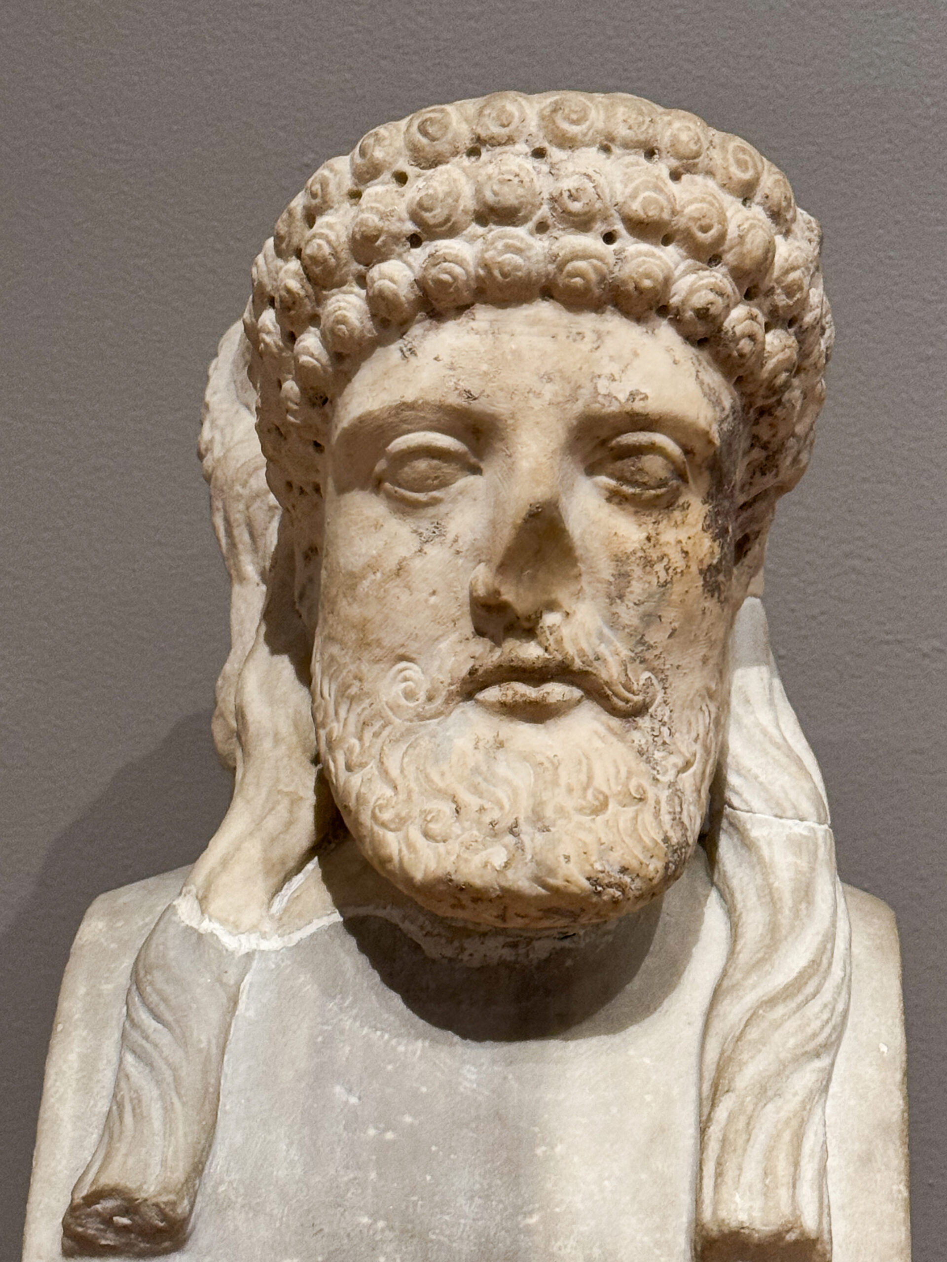 ancient-roman-marble-bust-with-detailed-beard-and-curled-hairstyle