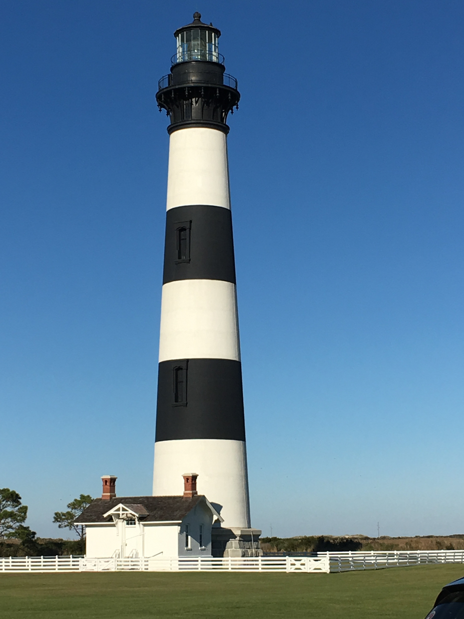 classic-striped-lighthouse-against-a-clear-sky-coastal-architecture-and-scenic-photography