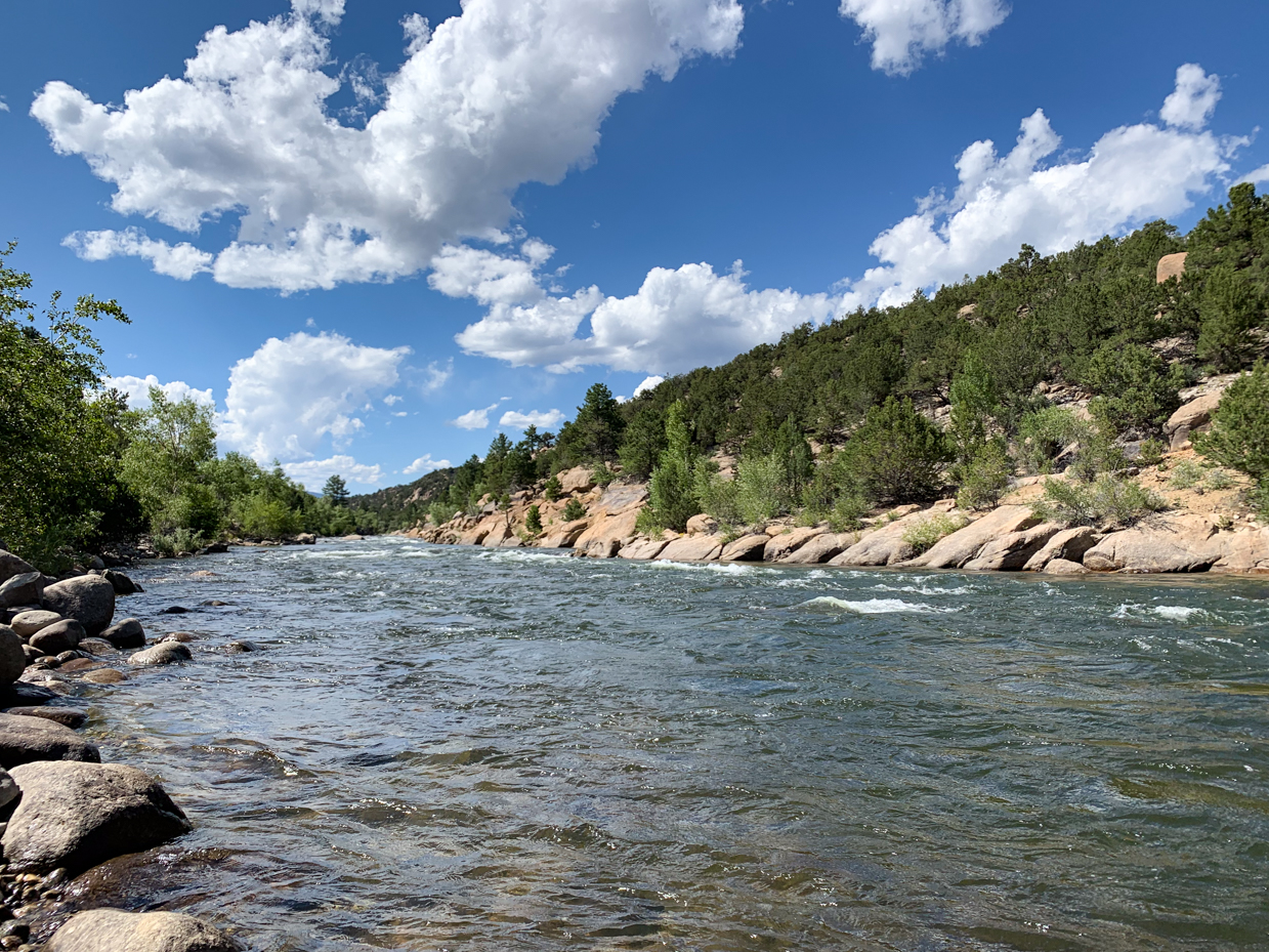 crystal-clear-river-flowing-through-rocky-landscape-and-green-forest-scenic-nature-photography