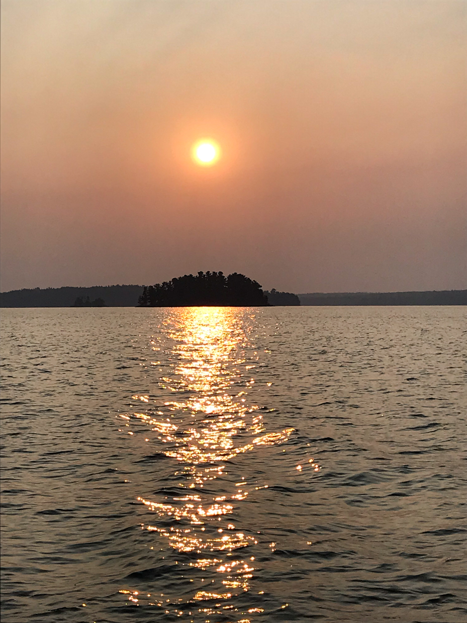 golden-sunset-over-calm-waters-with-silhouetted-island-tranquil-lake-photography