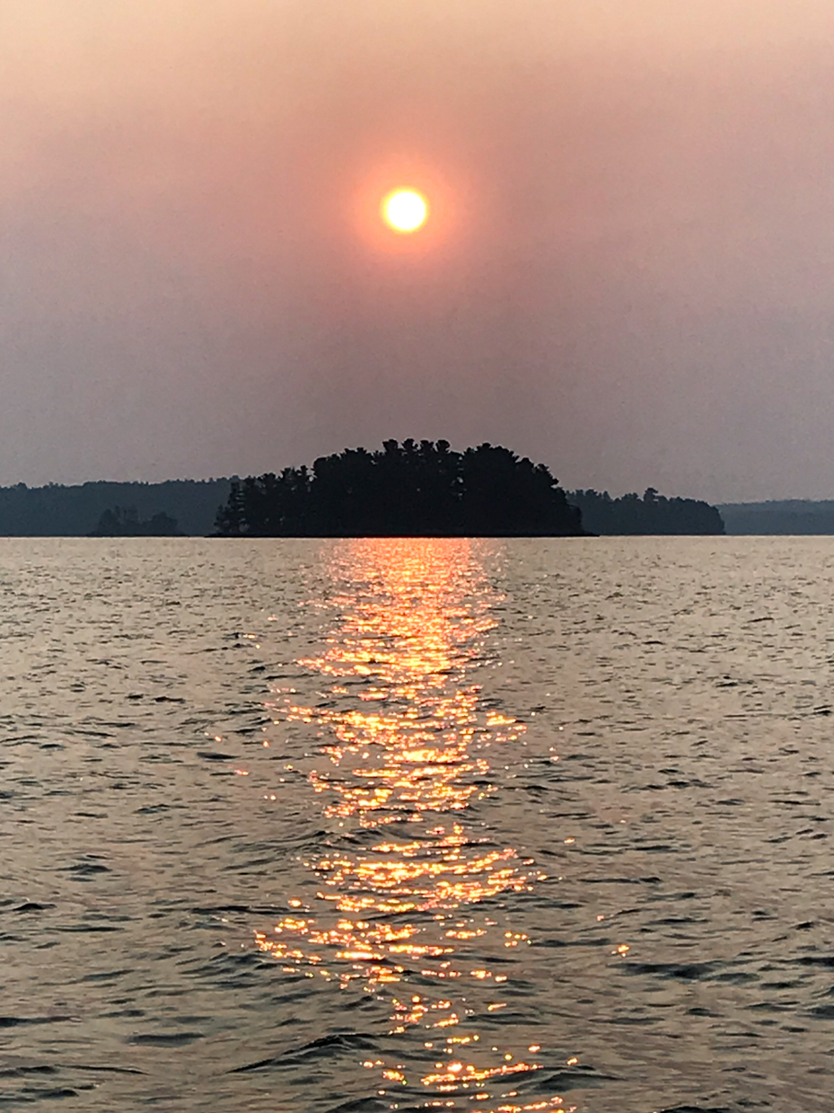 golden-sunset-reflection-on-calm-lake-with-silhouetted-island-captivating-nature-photography