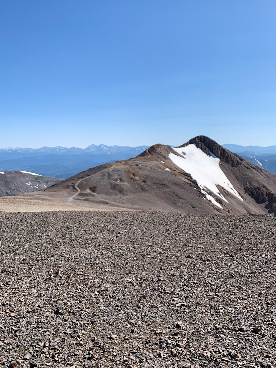 isolated-mountain-peak-with-snow-covered-ridge-and-rocky-terrain-remote-wilderness-photography