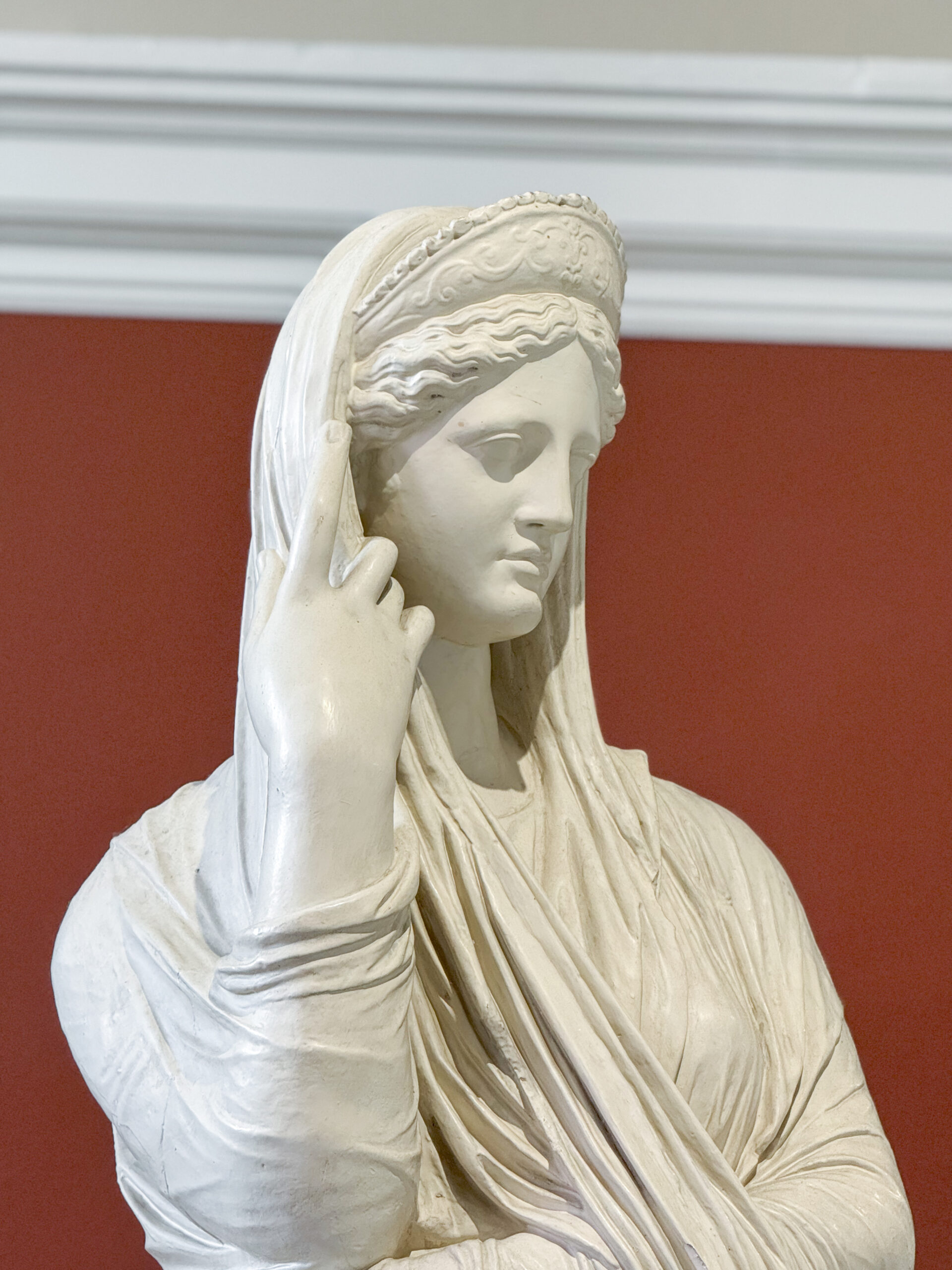 marble-statue-of-a-veiled-woman-with-detailed-drapery-and-serene-expression