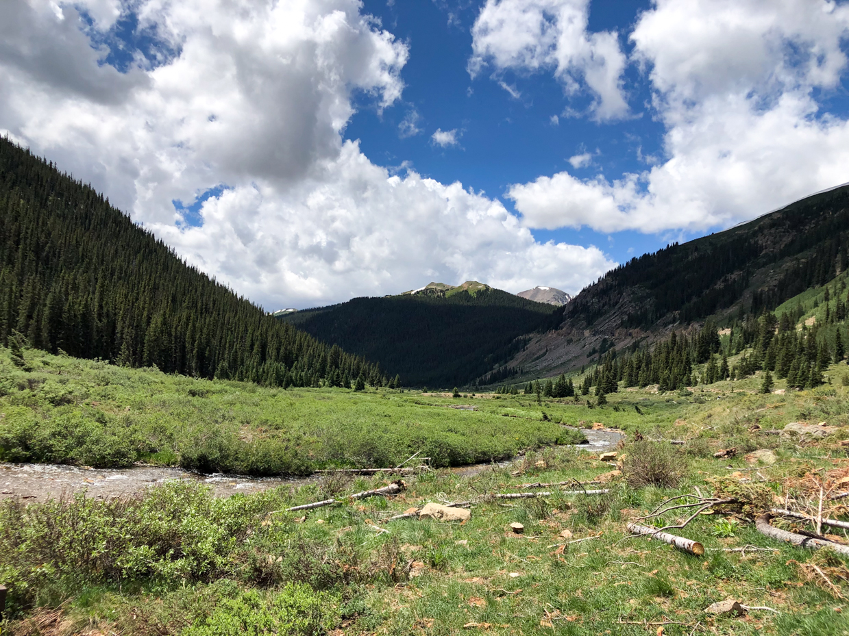 mountain-valley-landscape-with-stream-under-a-dramatic-sky-nature-photography-inspired