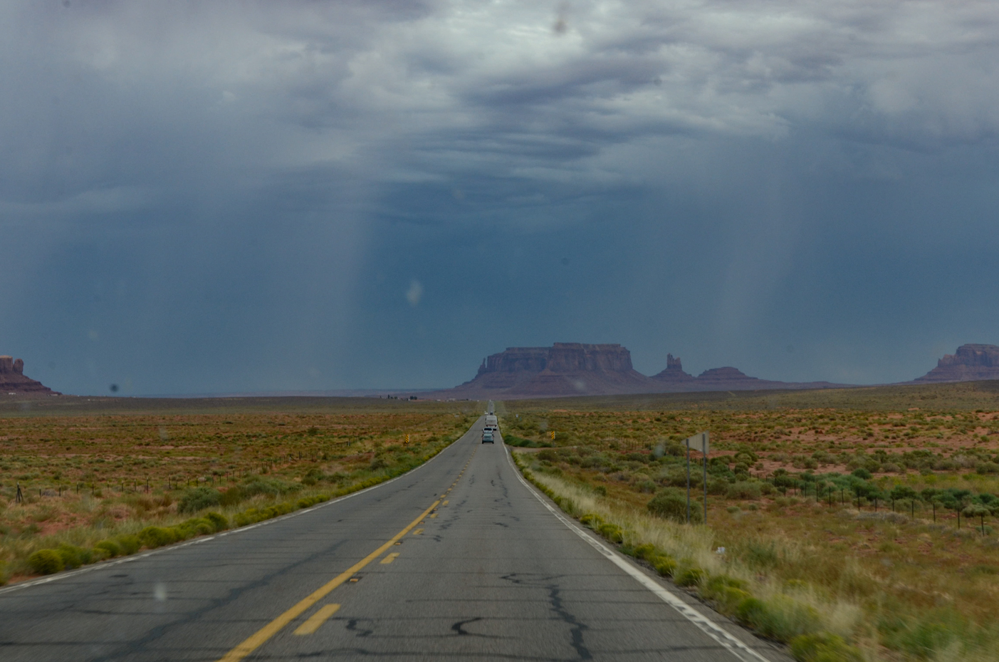 open-highway-leading-to-majestic-monument-valley-buttes-under-brooding-desert-sky