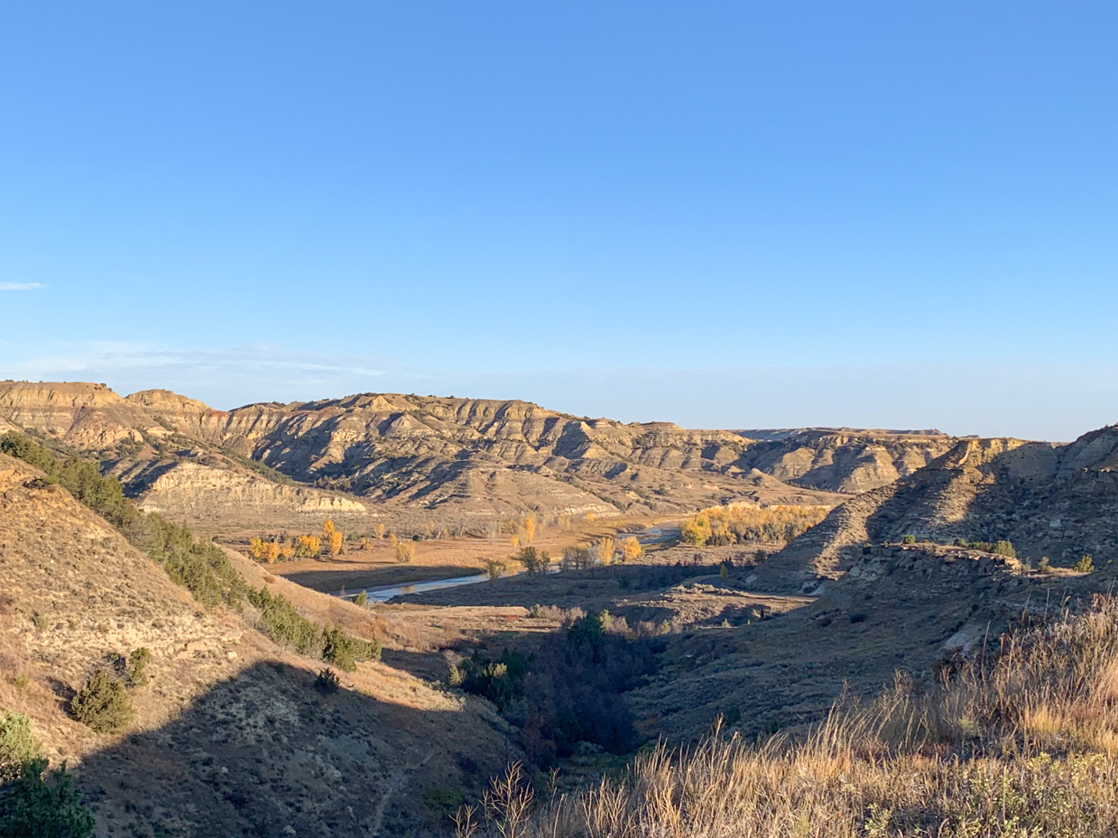 rugged-badlands-vista-with-autumn-river-oasis-western-landscape-artist-reference