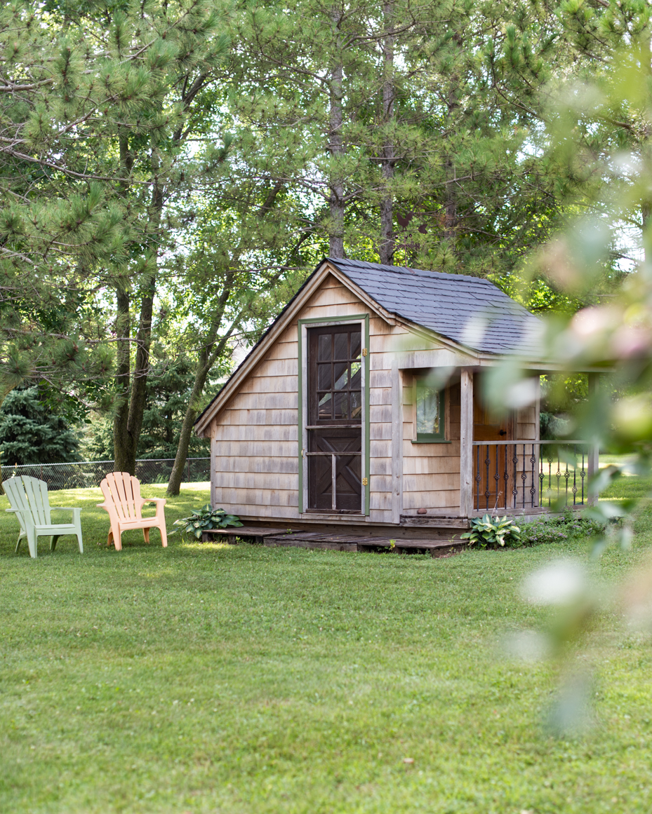 rustic-wooden-shed-in-lush-green-backyard-with-adirondack-chairs-cozy-garden-retreat-artist-reference-photo