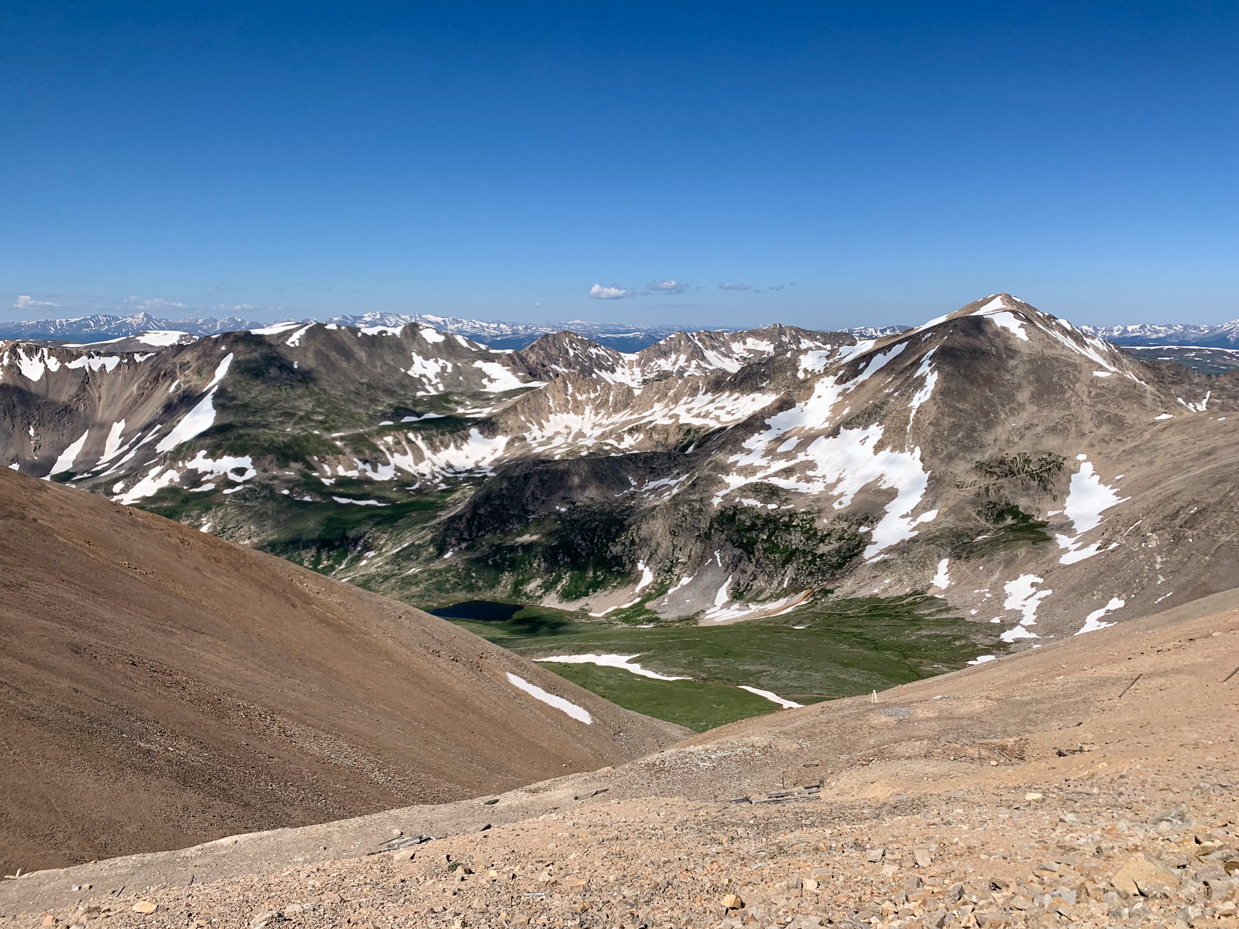 snow-capped-mountain-peaks-and-green-valleys-under-a-clear-blue-sky-majestic-alpine-landscape